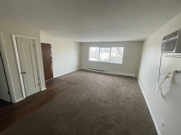 an empty room with windows and closet