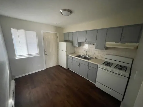 a kitchen with a stove a sink and a refrigerator
