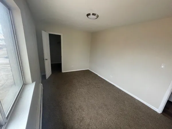 a view of an empty room and a window