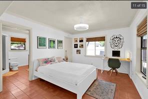 7301 Quicksilver Circle Austin, TX 78744 - Photo 7 of 15 a bedroom with a bed a table and chair