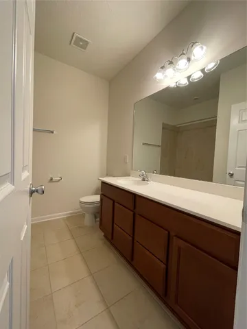 a bathroom with a sink mirror and vanity