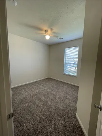 an empty room with a empty space and windows