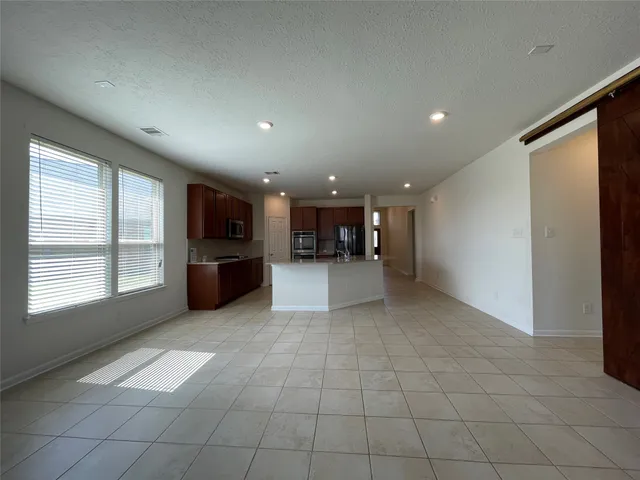 a view of a electric appliances in kitchen and windows