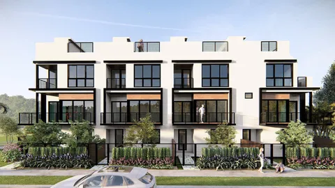 a front view of residential houses with yard and green space