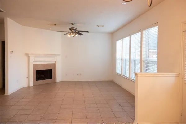 a view of a livingroom with a ceiling fan and window