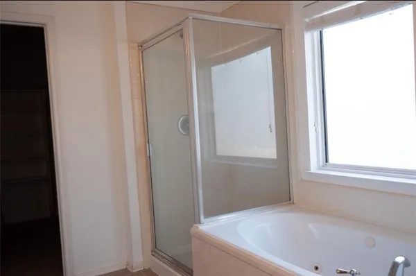 a bathroom with a granite countertop sink a toilet and a tub