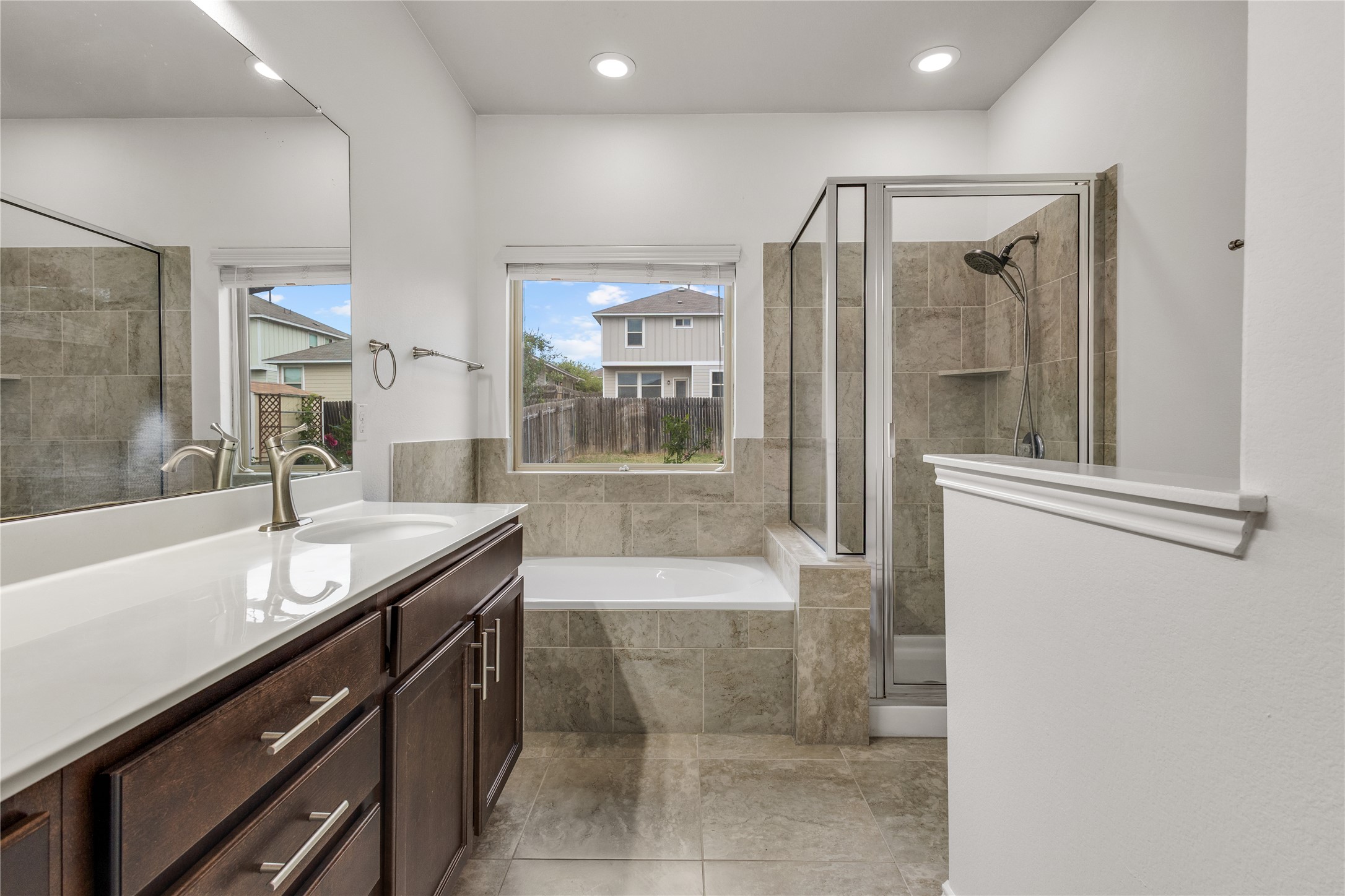 397 Limerick Road Buda, TX 78610 - Photo 19 of 33 The double vanity features rich wood cabinetry and sleek brushed nickel hardware.
