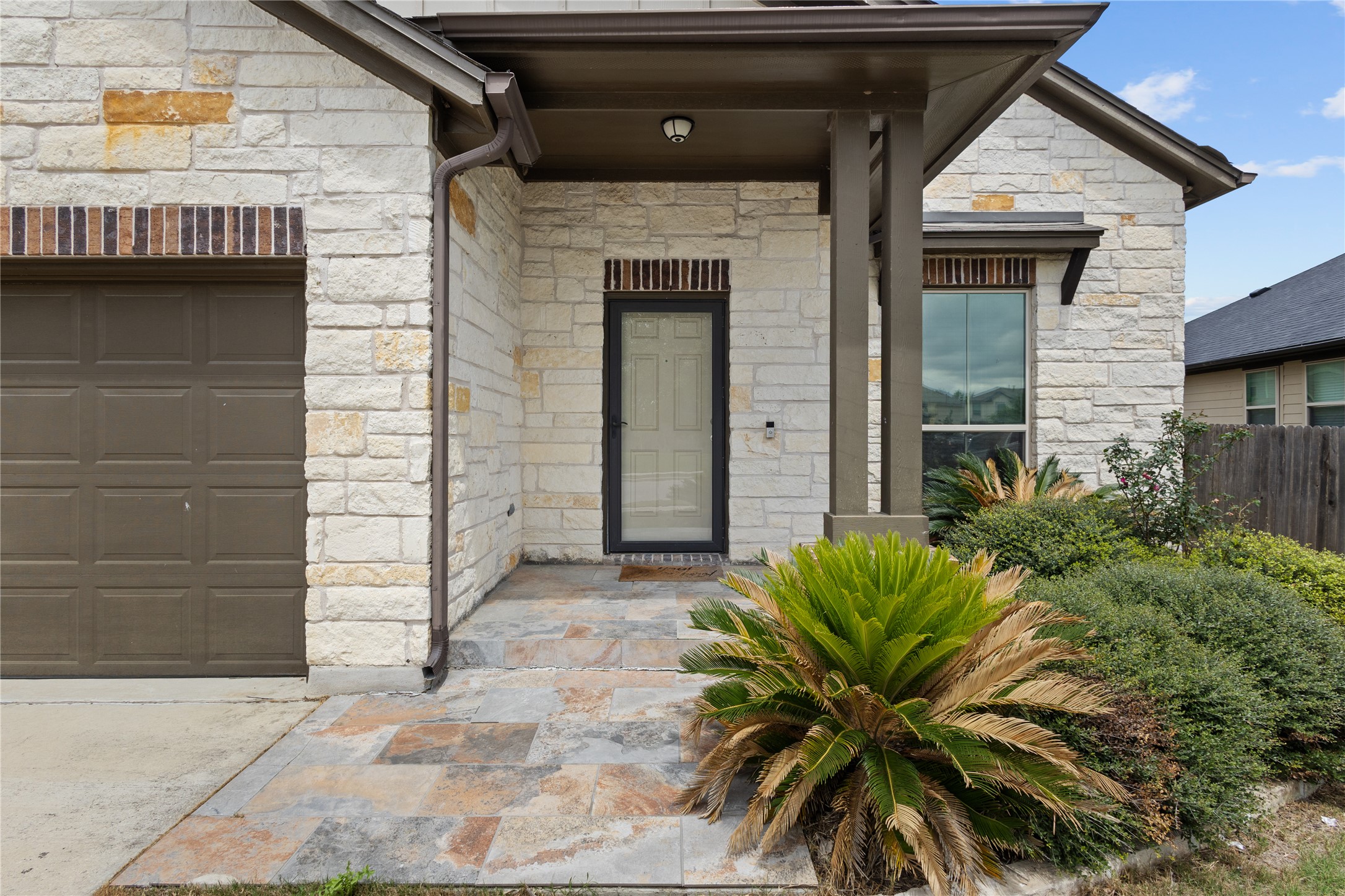 397 Limerick Road Buda, TX 78610 - Photo 2 of 33 Step onto a beautifully tiled porch that feels like a private courtyard complete with a storm door.