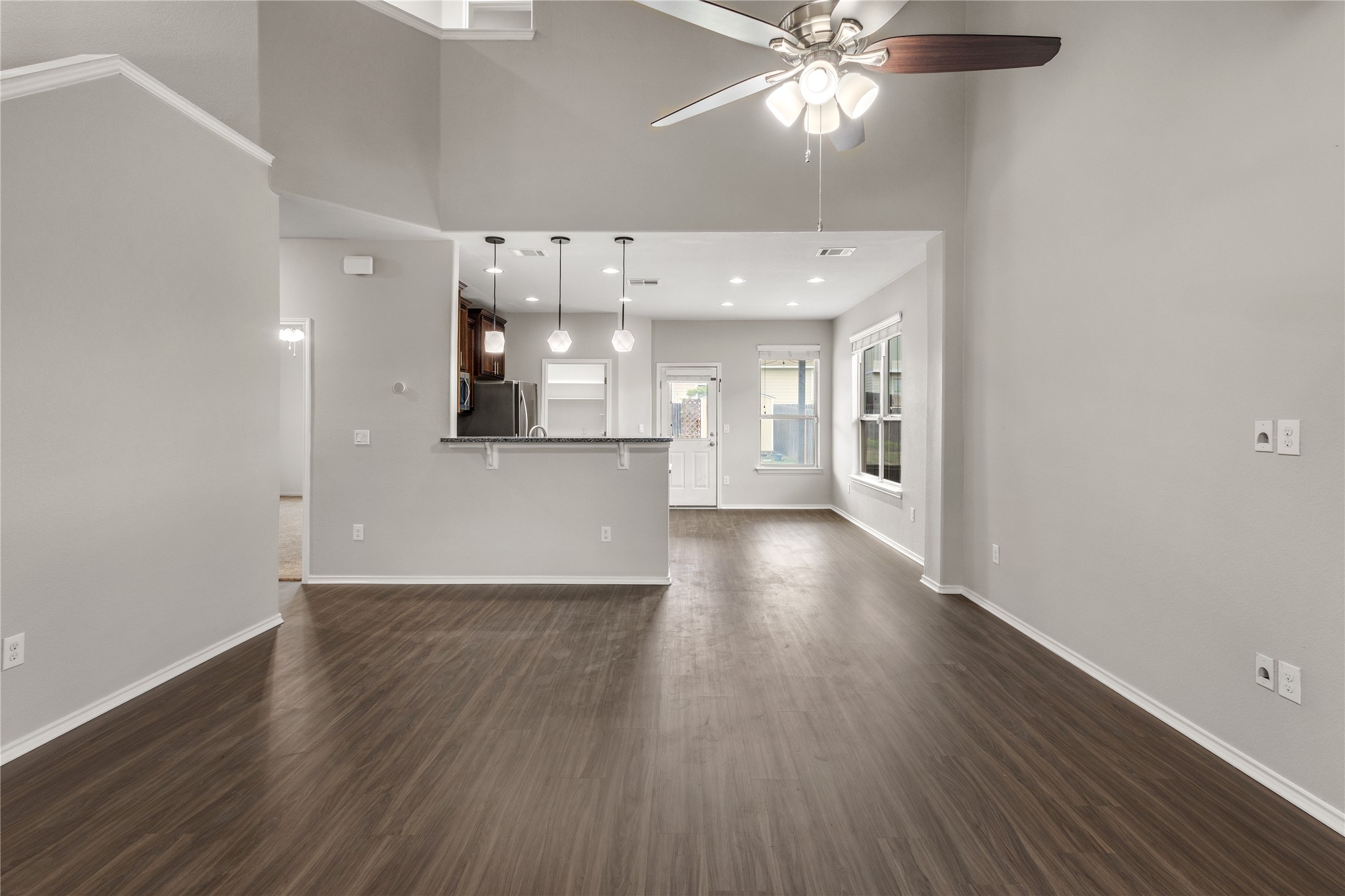 397 Limerick Road Buda, TX 78610 - Photo 4 of 33 With soaring vaulted ceilings and rich, wood-look flooring, the open-concept layout seamlessly connects the kitchen to the heart of the home—perfect for hosting game nights or quiet Sunday mornings.