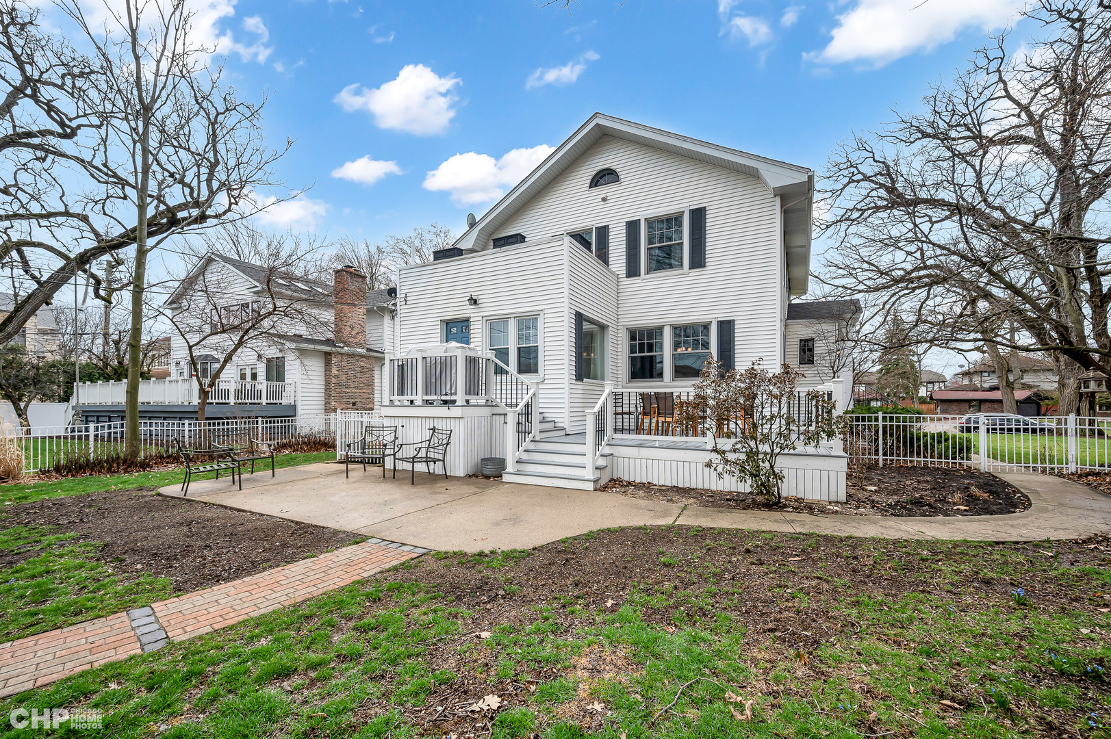 304 Maplewood Road Riverside, IL 60546 - Photo 23 of 38 a view of a white house that has a tree in front of it