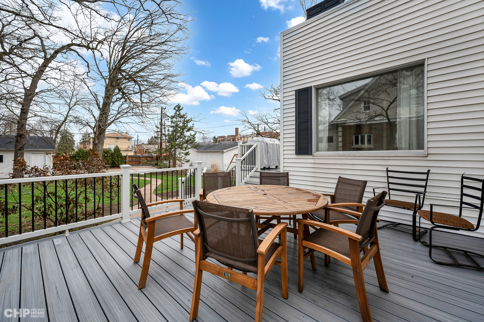 304 Maplewood Road Riverside, IL 60546 - Photo 24 of 38 a view of a roof deck with table and chairs and wooden floor