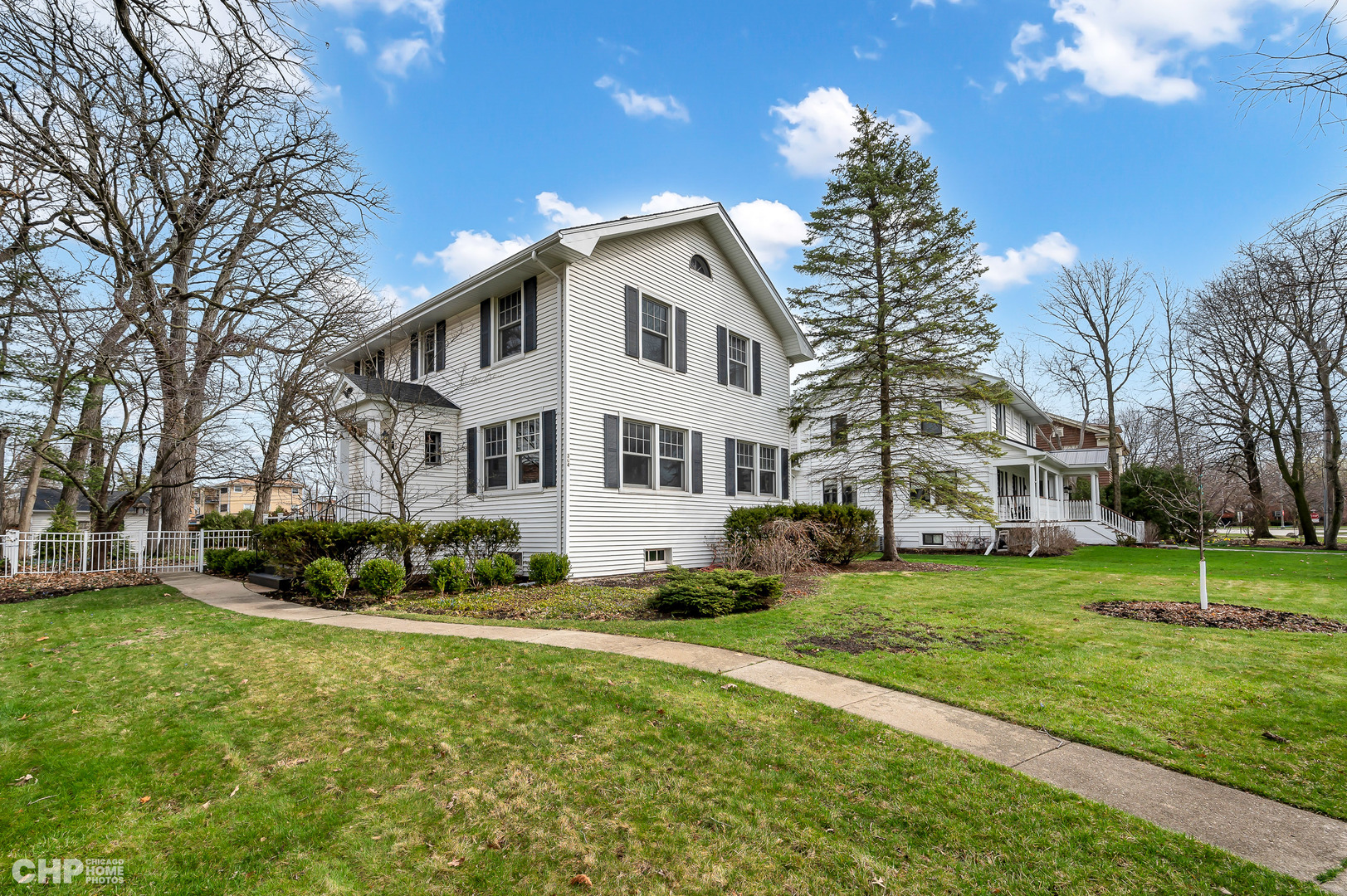 304 Maplewood Road Riverside, IL 60546 - Photo 3 of 38 a view of a white house with a big yard and large trees