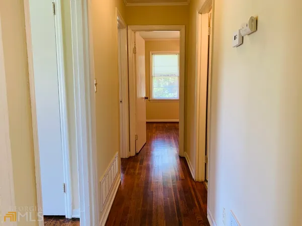 a view of a hallway with wooden floor