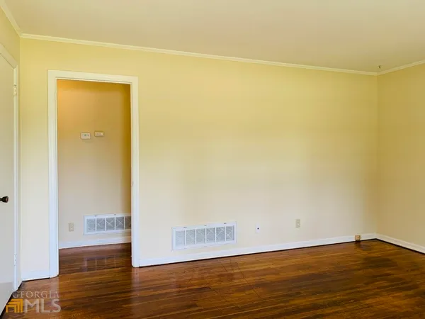 a view of a room with wooden floor