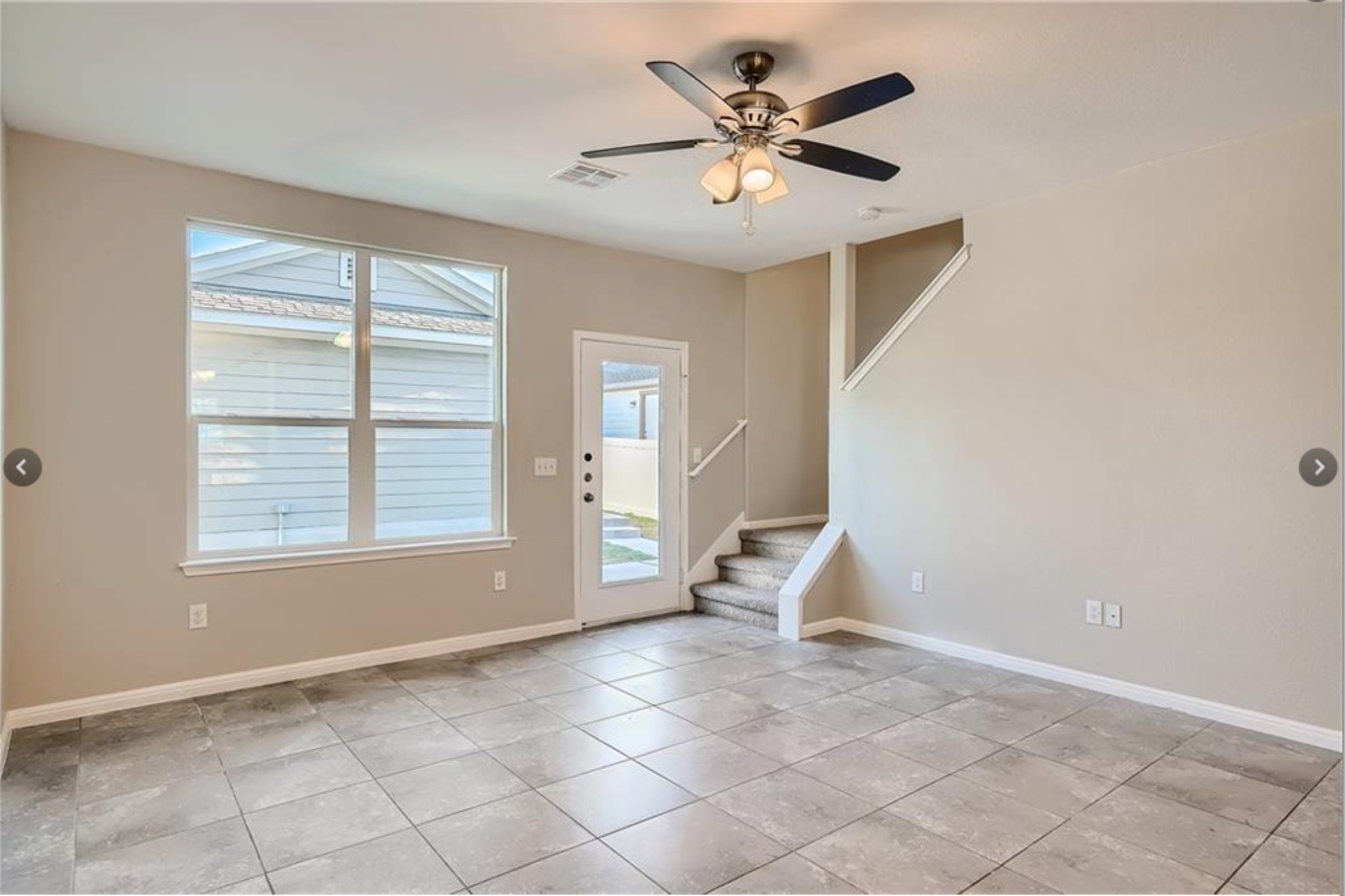 304 Cane River Road Pflugerville, TX 78660 - Photo 3 of 31 A versatile living area features tiled flooring, a prominent window, and direct outdoor access.