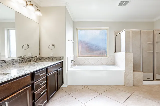 a bathroom with a granite countertop sink a mirror and a bathtub