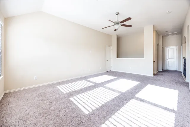 a view of a room with windows and ceiling fan