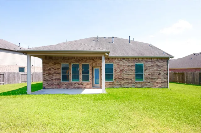a view of a house with a yard and sitting area