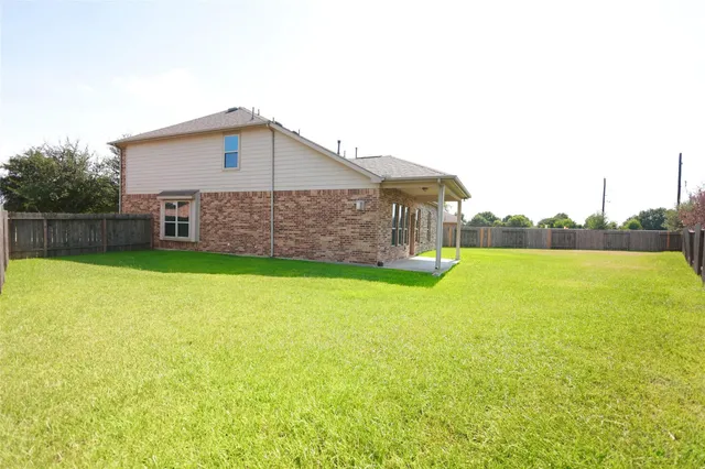 a green field with trees in the background
