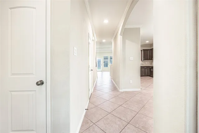 a view of a hallway with wooden shelves