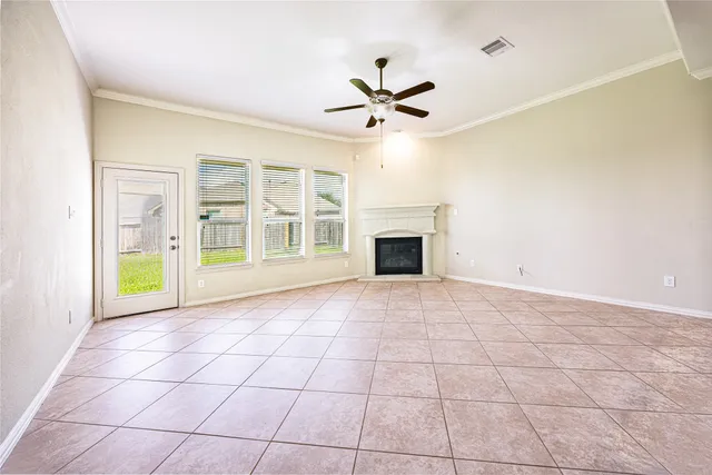 a view of an empty room with a fireplace and a window