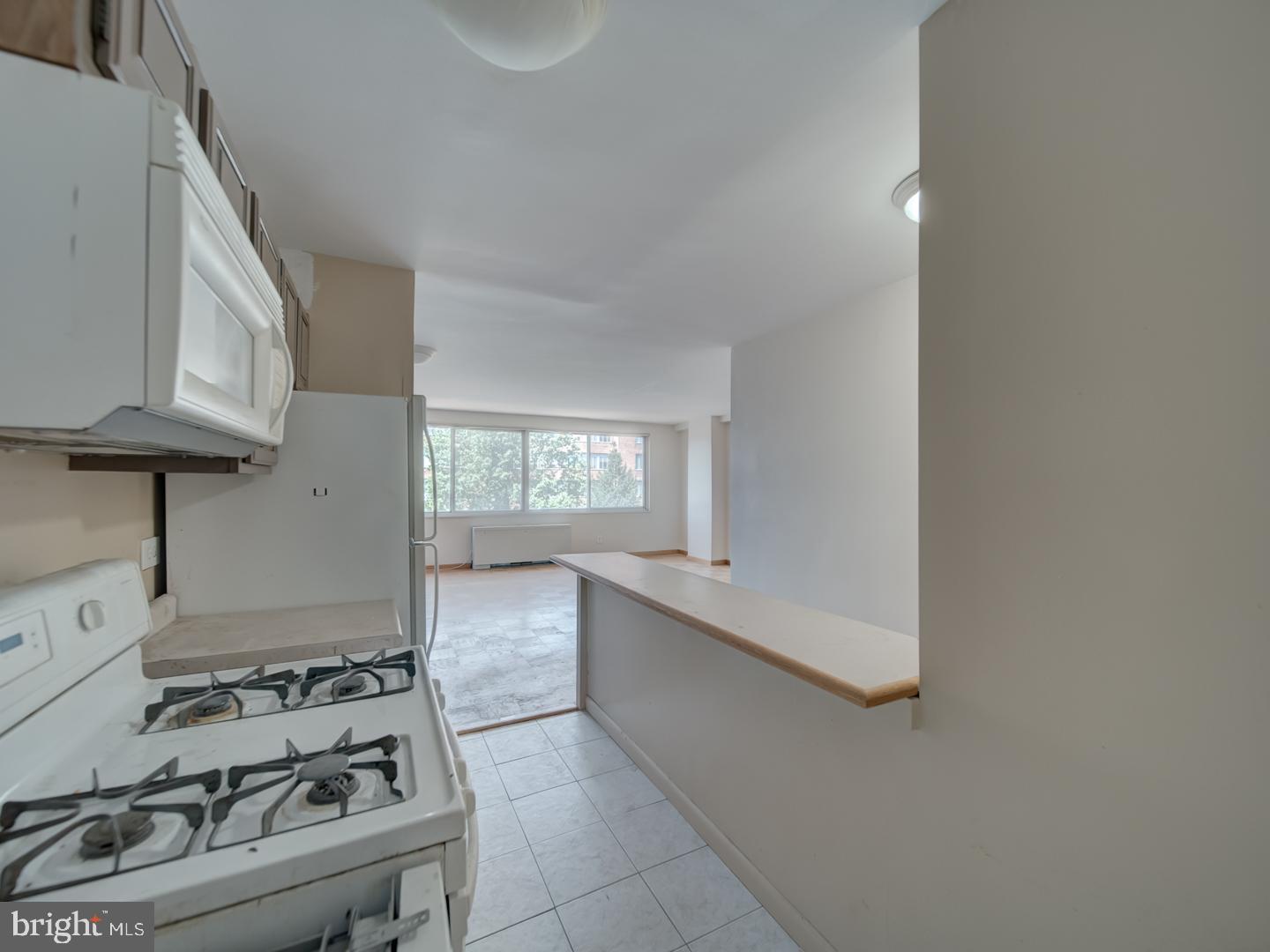 2829 Connecticut Avenue Northwest, Unit 606 Washington, DC 20008 - Photo 11 of 28 a kitchen with stainless steel appliances granite countertop a sink stove and cabinets