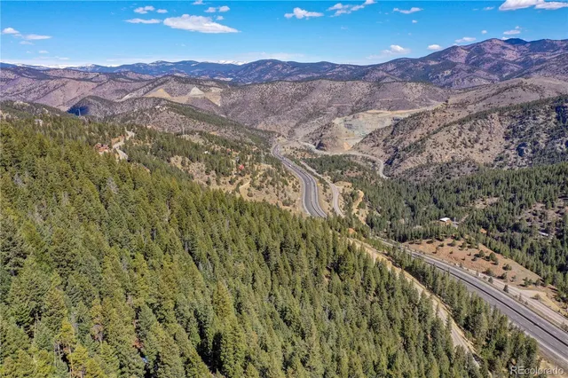 a view of a lush green hillside and houses
