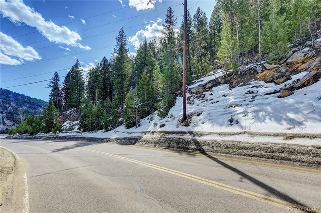 a view of a street with a house in the background