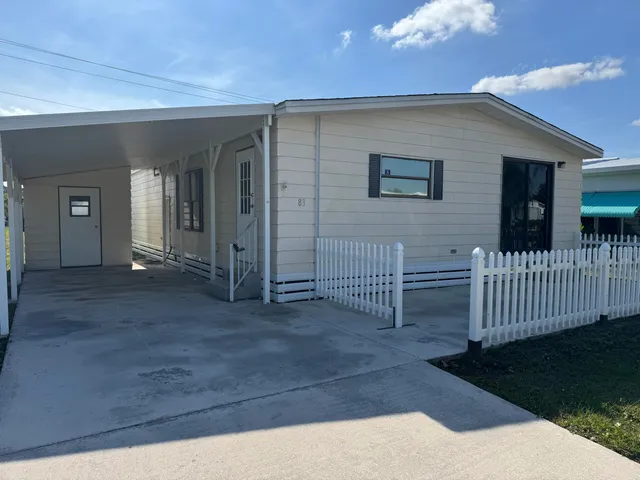 a view of a house with wooden fence