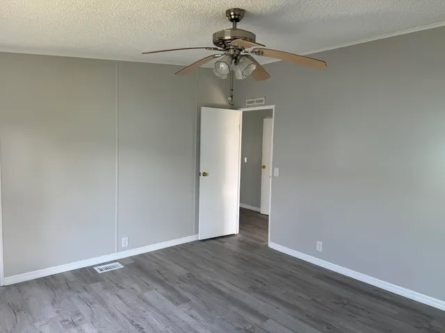 a view of an empty room and wooden floor