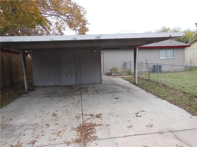 a view of a backyard with a cabin and wooden fence