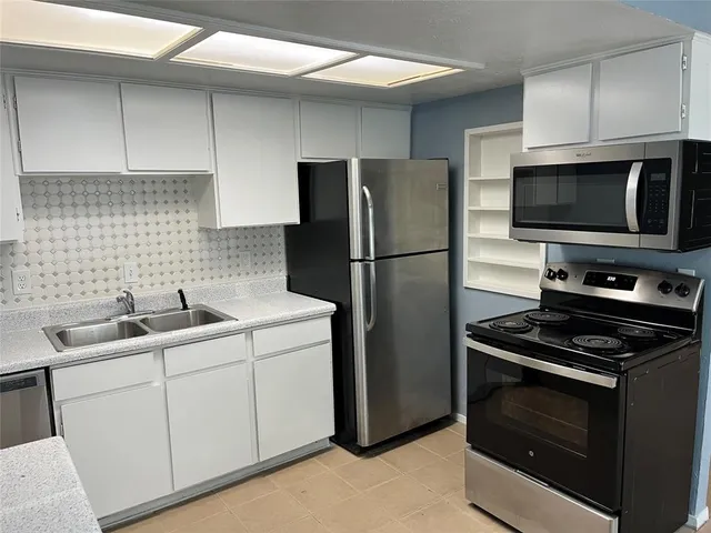 a kitchen with a sink stove and refrigerator