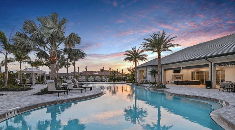 5357 Spoonflower Court St. Cloud, FL 34771 - Photo 5 of 8 a view of a swimming pool with a table and chairs