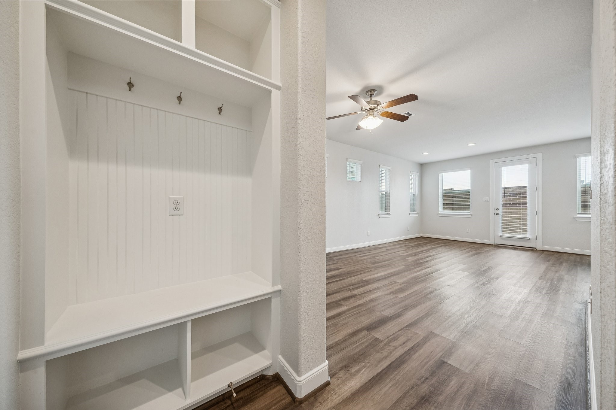 9817 Prairie Garden Lane Houston, TX 77080 - Photo 12 of 36 a view of an empty room with chandelier fan and wooden floor