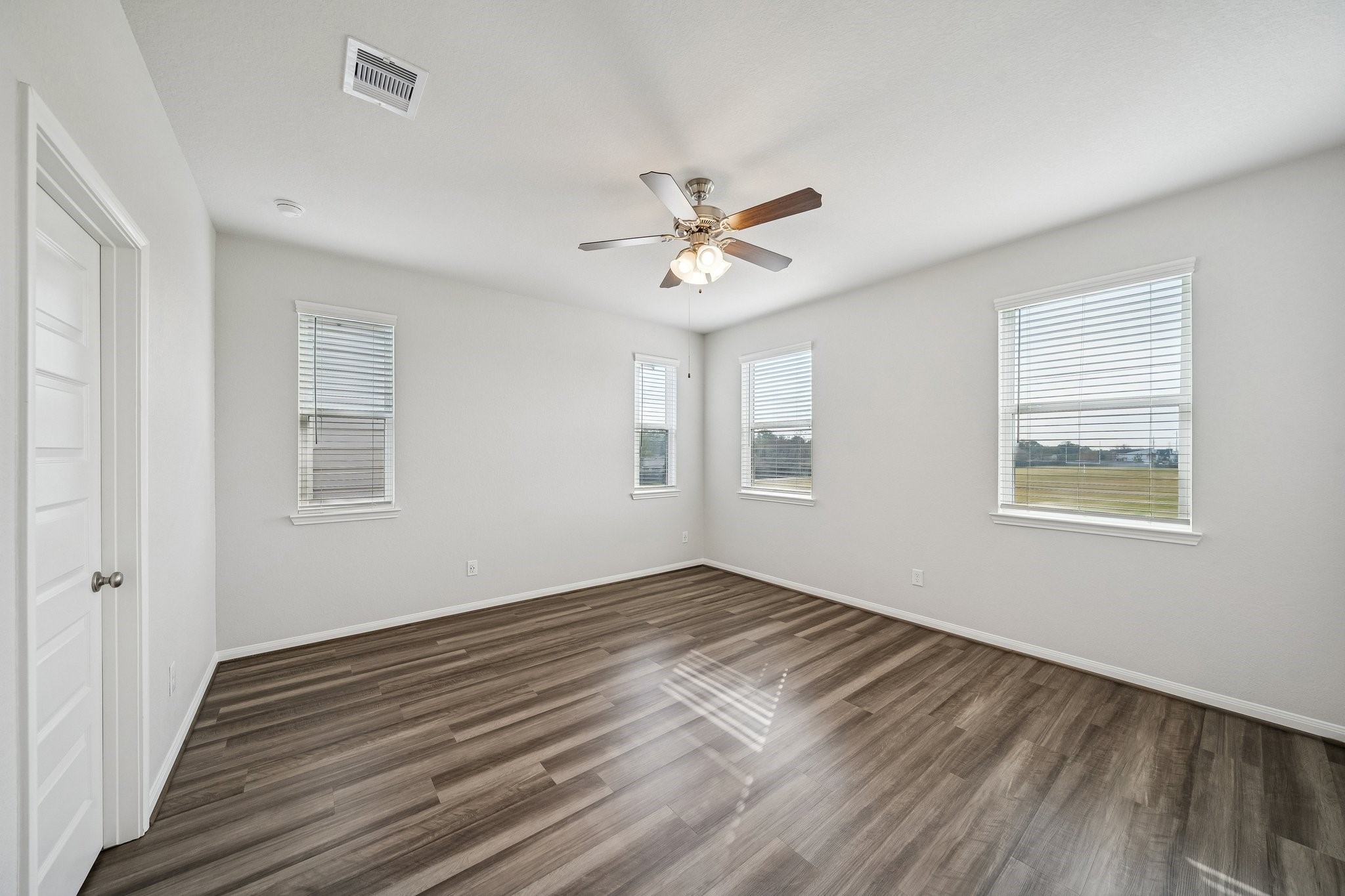 9817 Prairie Garden Lane Houston, TX 77080 - Photo 16 of 36 a view of empty room with wooden floor and fan