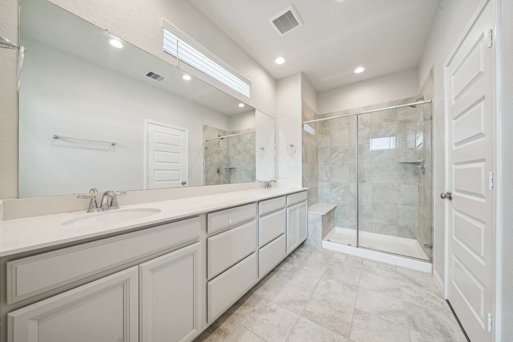 9817 Prairie Garden Lane Houston, TX 77080 - Photo 18 of 36 a spacious bathroom with a shower a sink and a large mirror