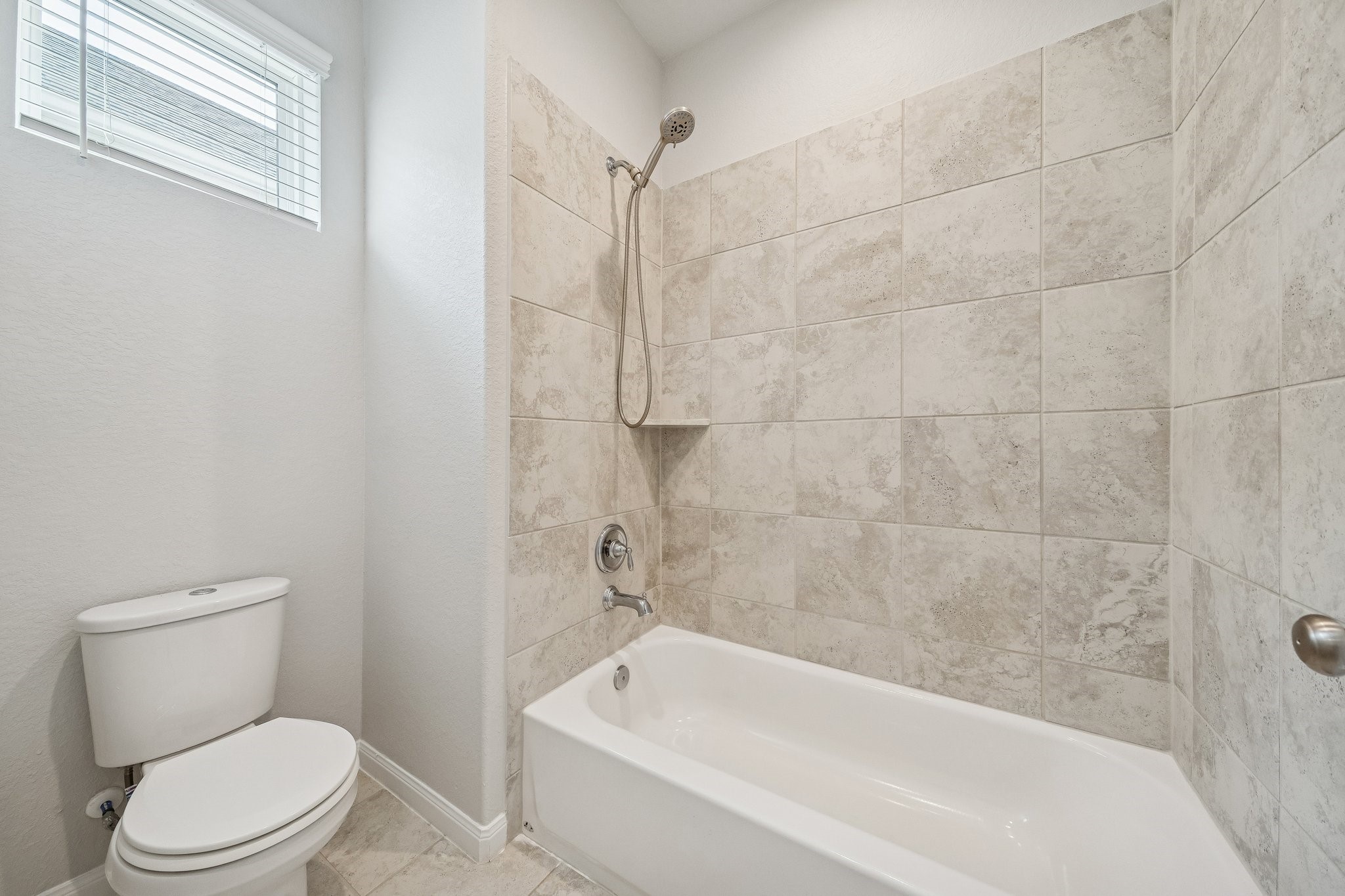 9817 Prairie Garden Lane Houston, TX 77080 - Photo 22 of 36 a white toilet and tub sitting next to a bathroom sink