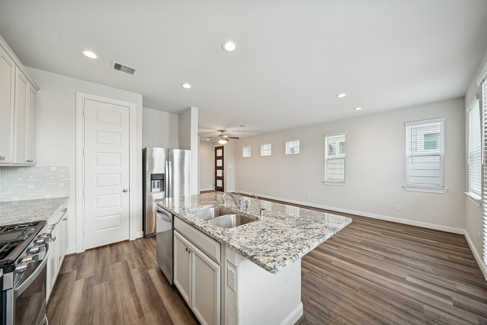 9817 Prairie Garden Lane Houston, TX 77080 - Photo 10 of 36 a kitchen with stainless steel appliances granite countertop a sink stove and refrigerator