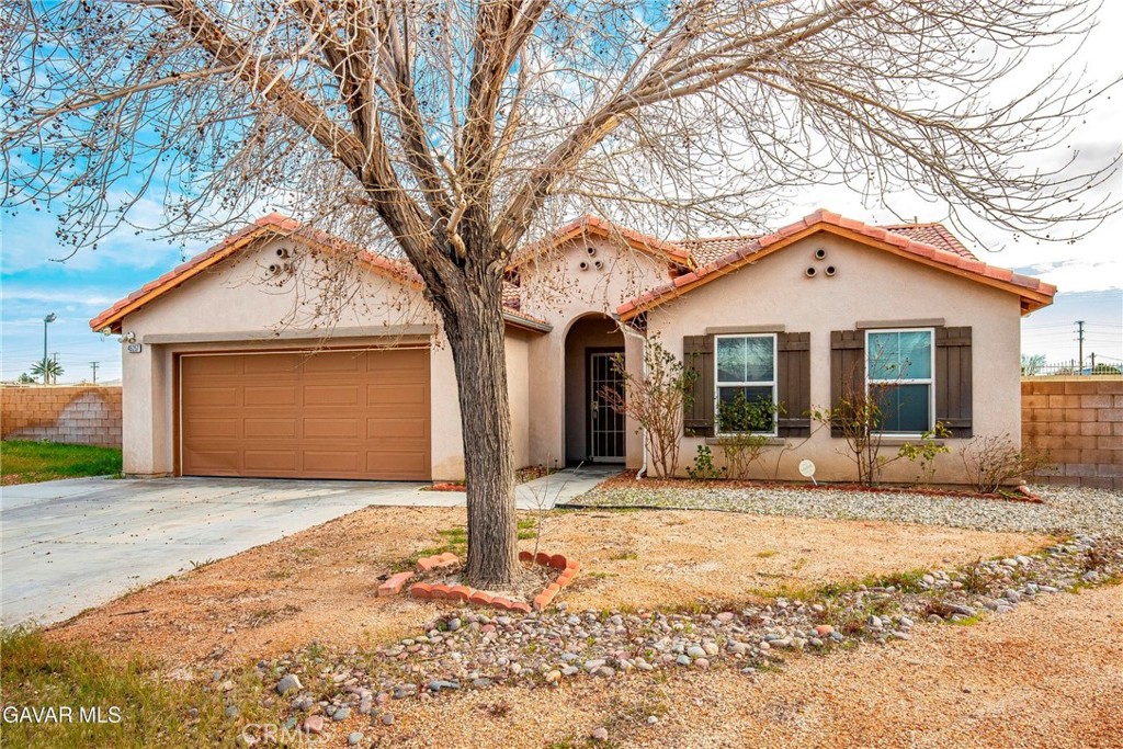 45257 Date Lancaster, CA 93534 - Photo 1 of 1 a front view of a house with a yard and garage