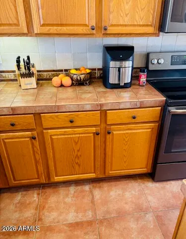 a view of a swimming pool with a patio and a garden