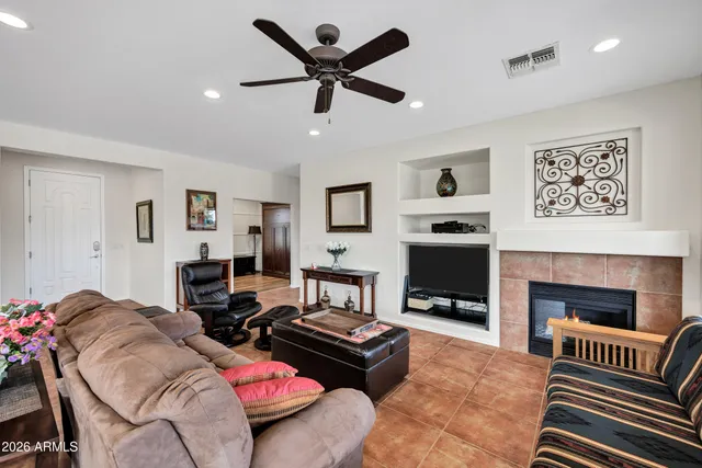 a living room with fireplace furniture and a chandelier