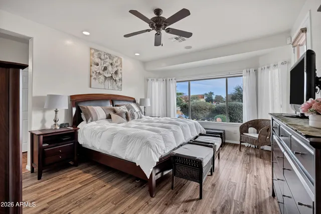 a room with lots of tables a large window and chairs