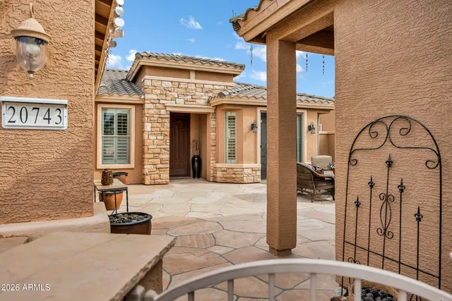 a living room with furniture ceiling fan and a flat screen tv