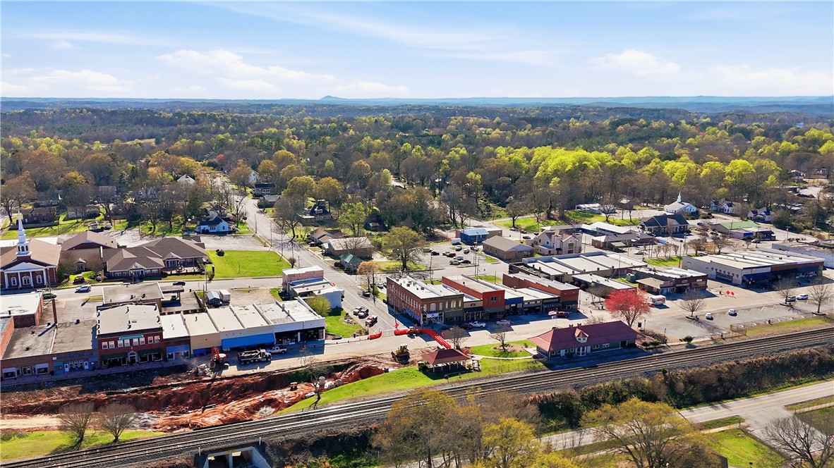 310 Retreat Street Westminster, SC 29693 - Photo 46 of 46 An aerial perspective showcases a town's layout, blending commercial spaces with verdant surroundings.