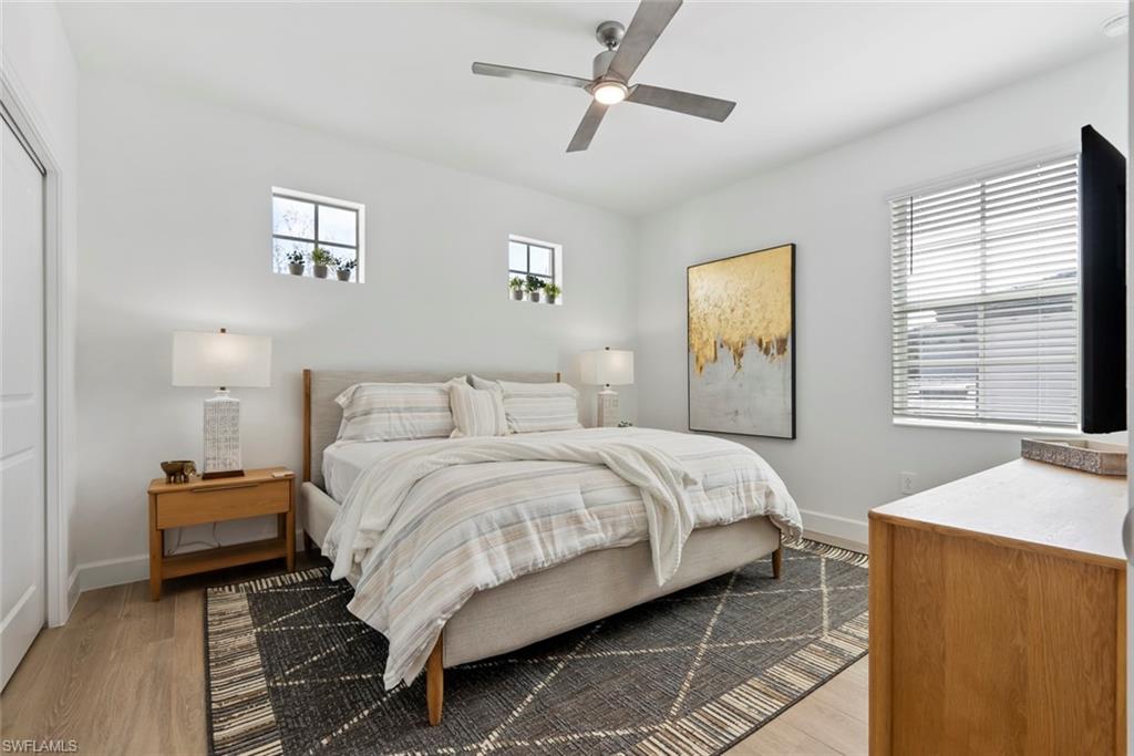 16889 Fairgrove Way, Unit 5201 Naples, FL 34110 - Photo 19 of 28 a bedroom with bed and a window