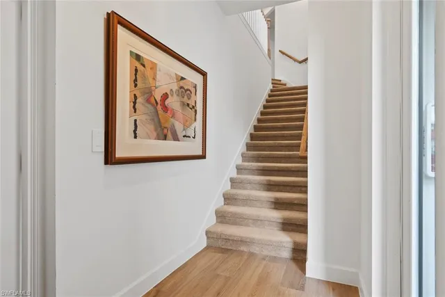 a view of staircase with wooden floor