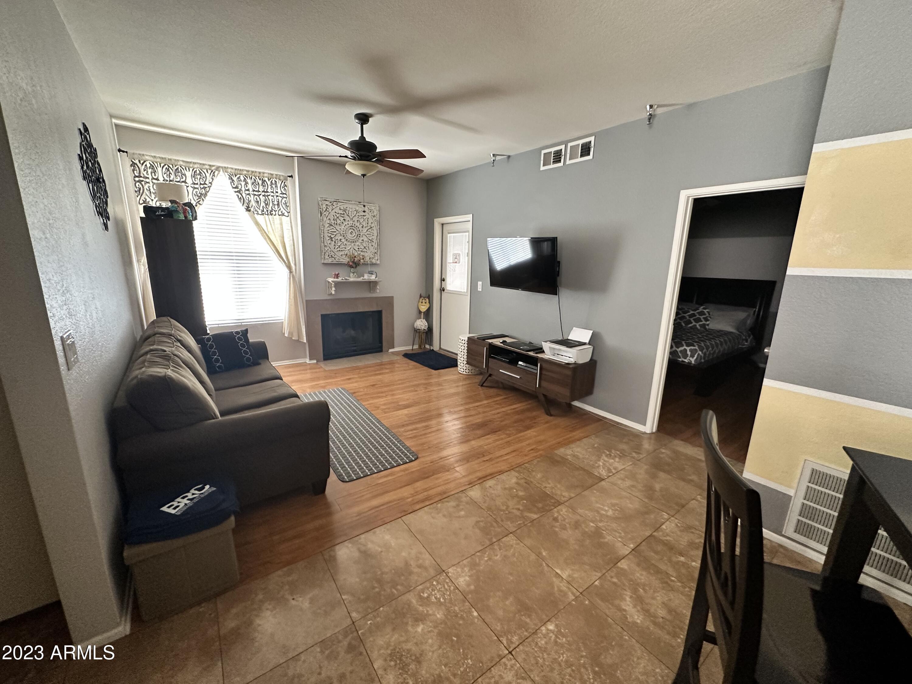 154 West 5th Street, Unit 149 Tempe, AZ 85281 - Photo 2 of 9 a living room with furniture and a flat screen tv