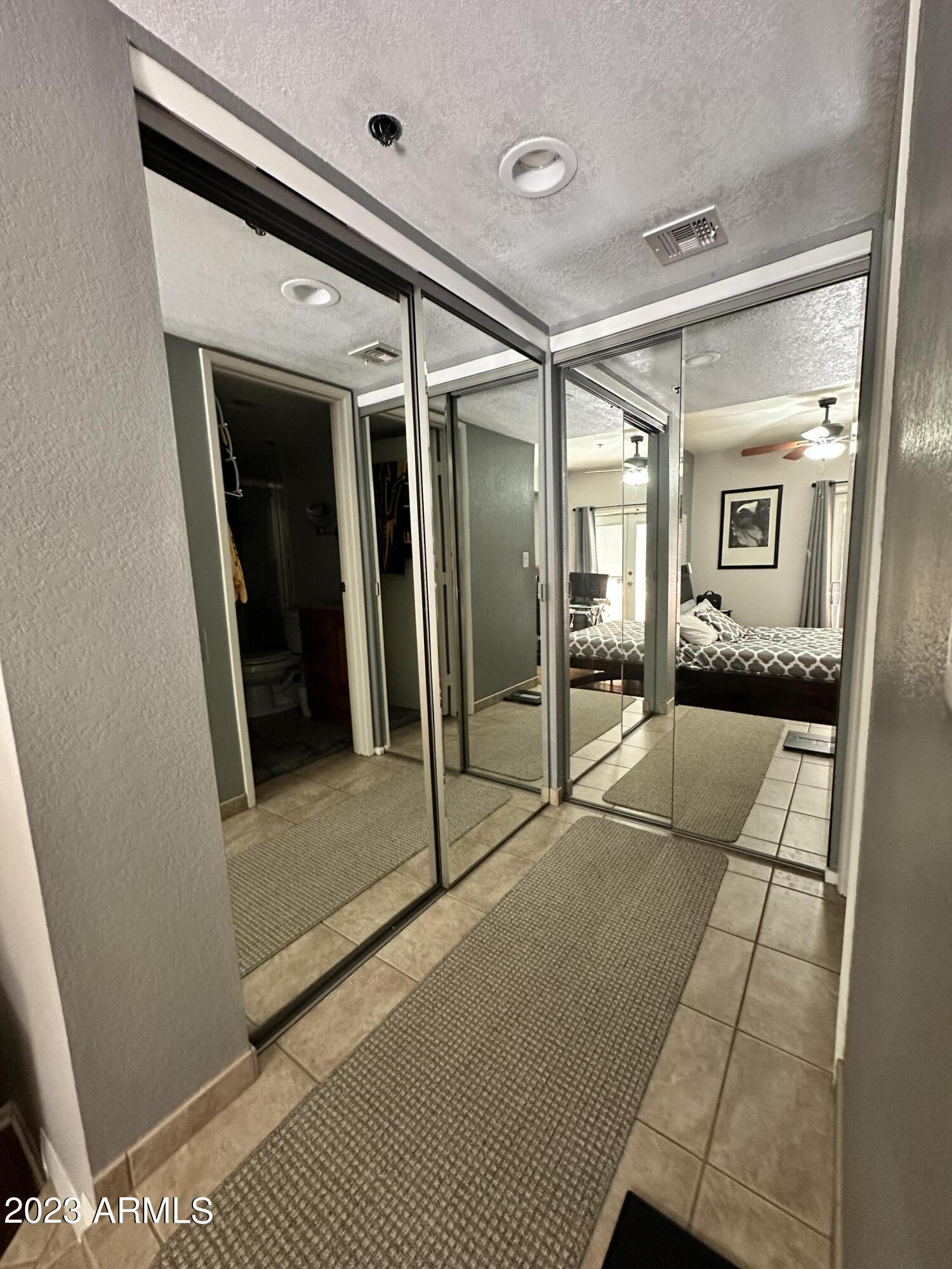 154 West 5th Street, Unit 149 Tempe, AZ 85281 - Photo 5 of 9 a bedroom with a bed and glass door