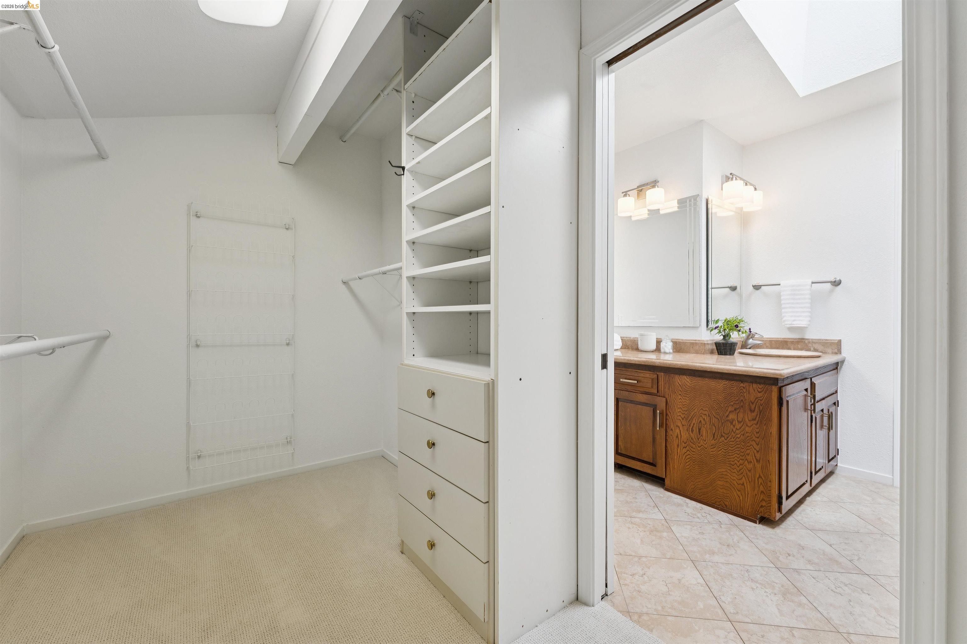7 Jo Lin Court El Sobrante, CA 94803 - Photo 77 of 99 Walk-in closet featuring carpet flooring, integrated shelving, and multiple hanging rods
