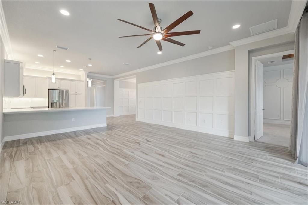 13418 Silktail Drive Naples, FL 34109 - Photo 12 of 36 a view of an empty room and wooden floor